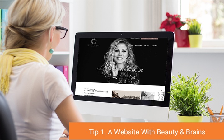 Woman looking at desktop with a beautifully designed website pulled up (Tip 1. A Website With Beauty & Brains)
