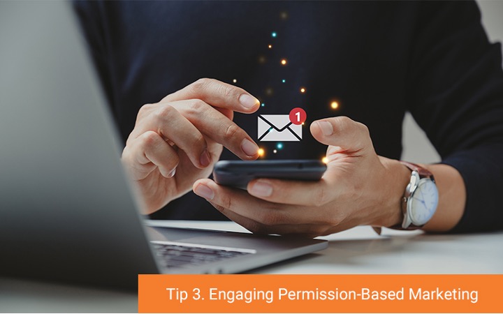 A person holding their phone looking at their screen with an email icon floating above the phone (Tip 3. Engaging Permission-Based Marketing)